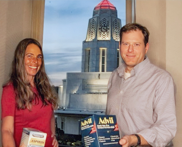 Mattine Gallentine, MG Computer owner, and Todd Gallentine, CTO, confidently holding an Advil, illustrating their capability to alleviate IT headaches with effective solutions.